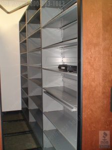 Vertical filing shelves store records on open shelving