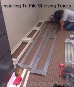 Installing tri-file shelving floor tracks