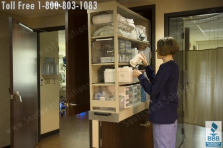 nurse server cabinets storing restocking medical supplies