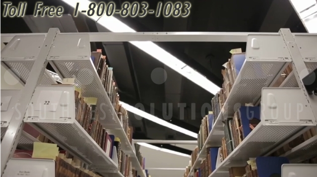 library space saving perforated shelves on mobile tracks