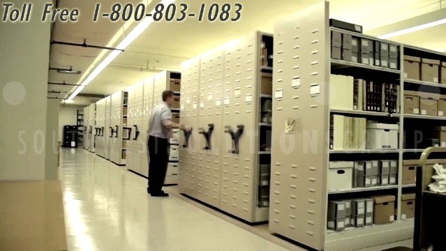 Compact Library Book Shelving On Tracks Turn Static Aisles Into Storage Space High Density Storage Shelving Compact Racks Space Saving File Cabinets