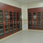 Built in wall cabinetry thermofoil glass doors storing medical products for hospitals