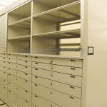 Drawers in shelving locking storage above doors