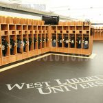 Football pads above storage locker university athletic locker room team sports storage