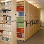 Library compact book shelves mechanical assist high density shelving