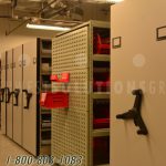 Mass storage system shelving cabinet on tracks