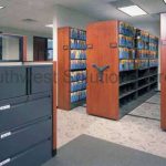 Mechanical assist high density shelving file cabinets