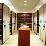 Mechanical assist high density storage mobile shelving system library law