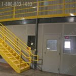 Mezzanine stairs over modular office space in warehouse