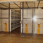 Mobile shelving protected with wire partition cage industrial storage