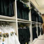 Police evidence property quartermaster storage shelving racks cabinets clothing handing uniforms on hangers