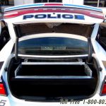 Police sedan vehicle trunk gun locker