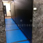 Roll down door secures parachute storage on track shelving