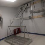 Wheelchair lift powered overhead electric rack storage