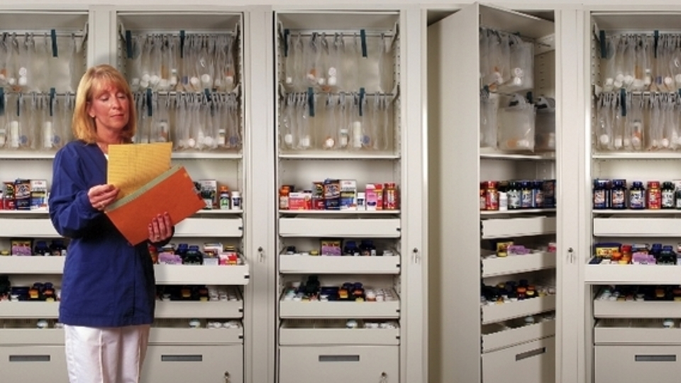 Medicine Bottles in Row on Storage Shelf Stock Image - Image of