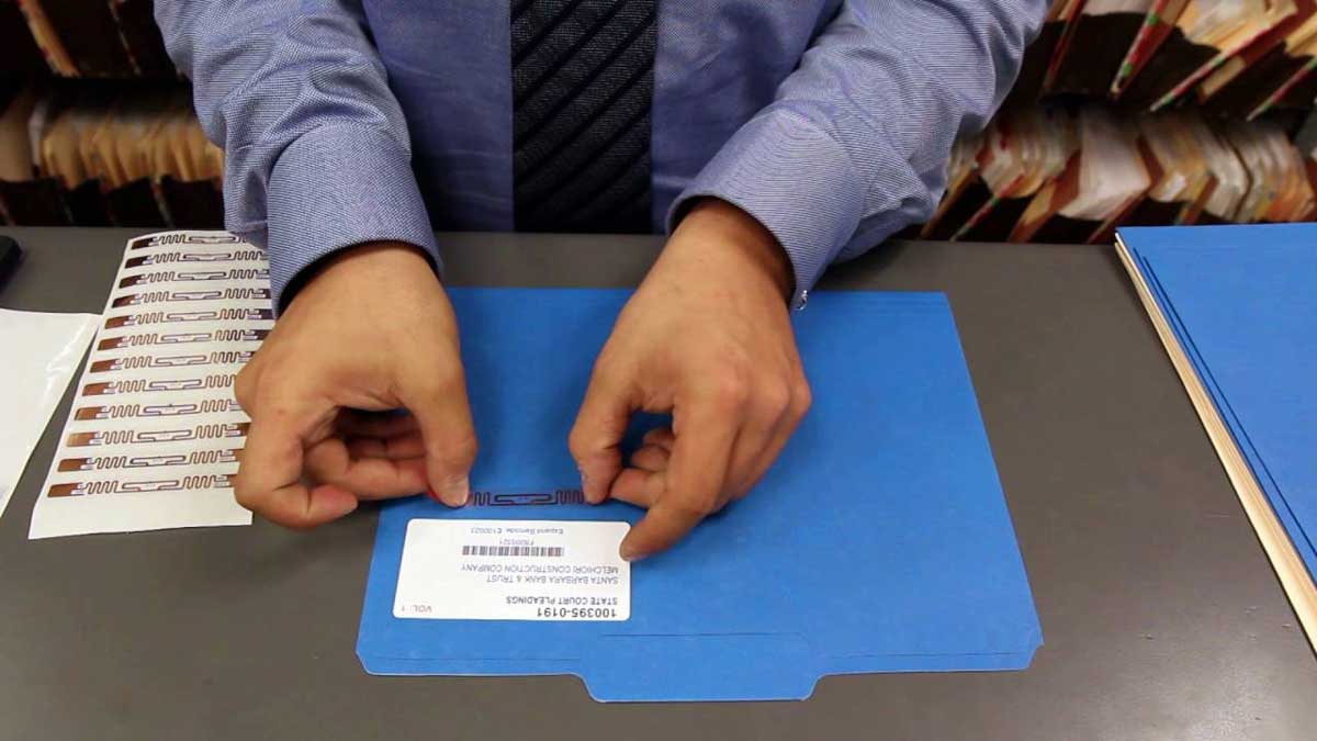applying rfid tag to labeled file folder