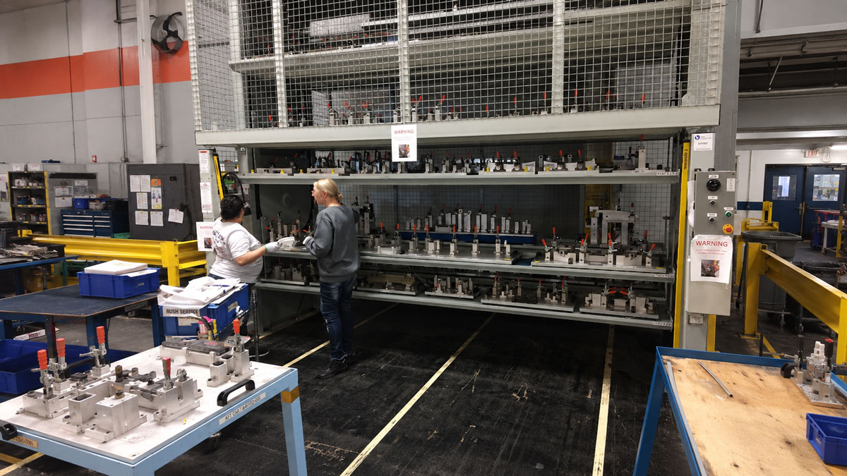 vertical shelving carousel storage system for organized industrial parts inventory